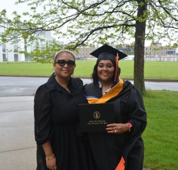 Student smiling with family at graduation