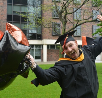 Student smiling with balloons